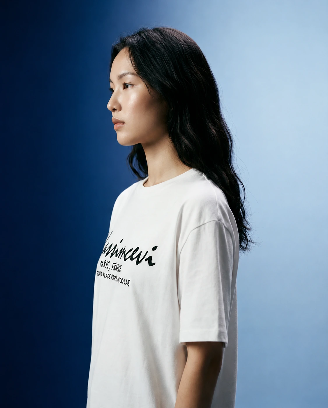 Profile portrait wearing the Place Roger Nicolas × Kassimcevi white T-shirt